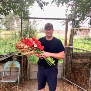 Andy Schalk with an armload of cut gladiolas