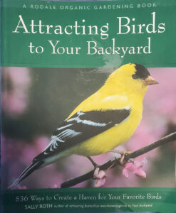 Front cover of Attracting Birds to Your Backyard by Sally Roth. Features a goldfinch