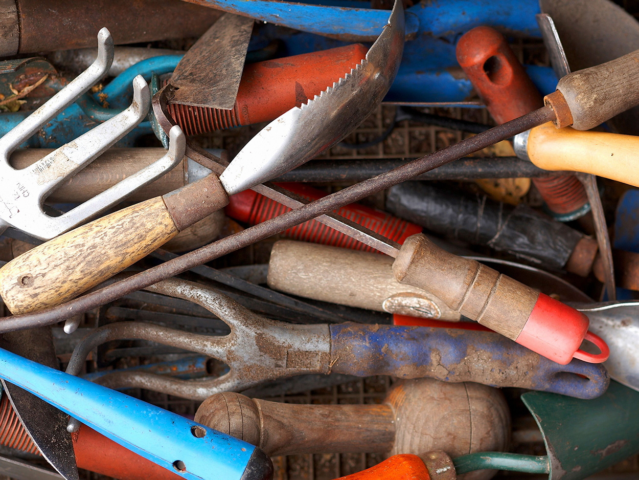 A pile of hand tools for gardening