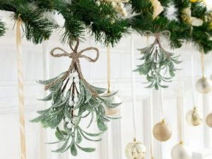 bunches of mistletoe hanging from evergreen garlands