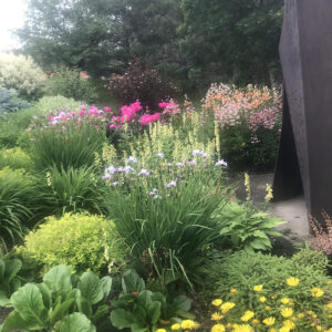 A perennial bed featuring lilies, peonies, etc.