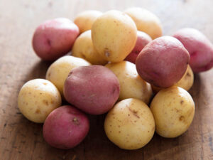 a pile of red and yellow new potatoes